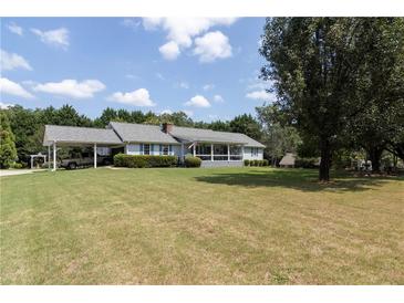 Ranch style home with carport, large yard, and screened porch at 445 Hinton Rd, Social Circle, GA 30025