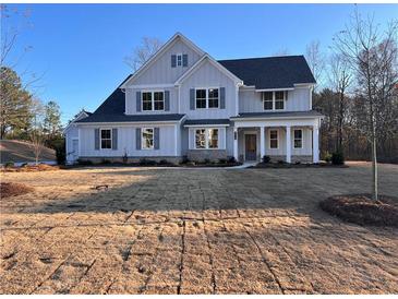 Two-story farmhouse with gray siding, brick accents, and a landscaped yard at 2719 Byess Ct, Marietta, GA 30064