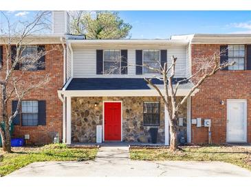 Brick townhouse with red front door and stone accents at 1468 Springleaf Se Cir, Smyrna, GA 30080