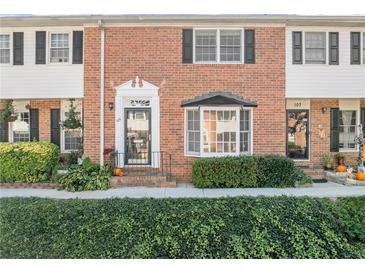 Brick front exterior of charming townhome with well-manicured landscaping at 6520 Roswell Rd # 106, Atlanta, GA 30328