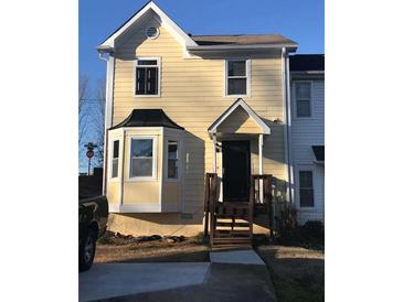 Cute yellow two-story house with a bay window and brown wooden steps at 800 Crestside Ct # 800, Austell, GA 30168