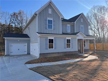 Two-story house with gray siding, two-car garage, and landscaped yard at 2723 Byess Ct, Marietta, GA 30064