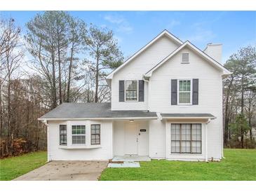 Two-story white house with gray shutters, landscaping, and a driveway at 9343 Haley Ct, Jonesboro, GA 30238