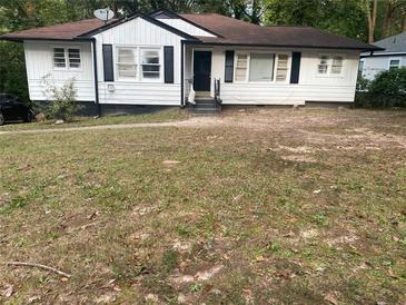 White Ranch home with black accents and a large yard at 1599 Sandtown Sw Rd, Atlanta, GA 30311