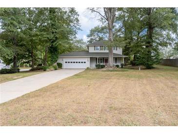 Two-story house with a large yard and driveway at 15 Ashton Pl, Covington, GA 30016