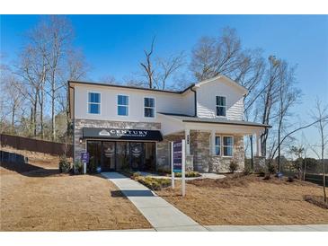 Two-story home with stone accents and a landscaped yard at 5559 Rosehall Pl, Atlanta, GA 30349