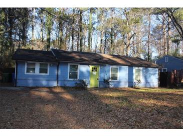 Ranch style home with blue siding, green door and mature trees at 1026 Valley View Rd, Atlanta, GA 30315