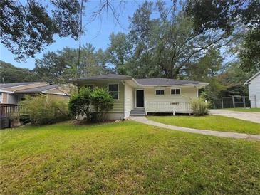 Ranch style home with a spacious yard and walkway at 2103 Mcafee Rd, Decatur, GA 30032