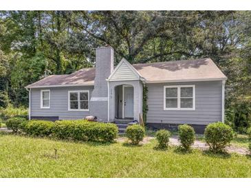 Gray house with white trim, landscaping, and a chimney at 360 Peyton Sw Rd, Atlanta, GA 30311