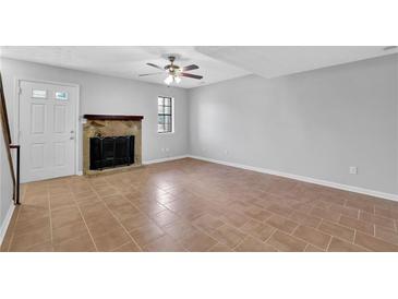 Bright living room with tile floors, fireplace, and ceiling fan at 731 Victoria Sw Pl, Atlanta, GA 30310
