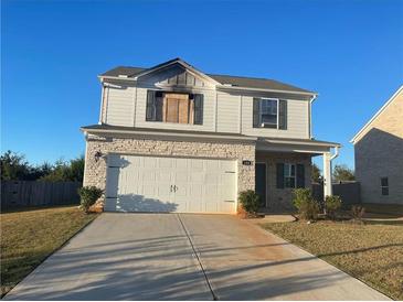 Two-story house with white siding, stone accents, and a two-car garage at 180 Oliver Dr, Locust Grove, GA 30248