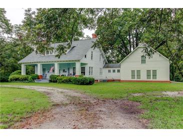 Charming white farmhouse with large wrap-around porch and detached building at 788 S Hwy 11 S, Social Circle, GA 30025