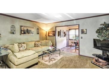 Spacious living room featuring a comfortable sectional sofa and large windows at 68 Montre Nw Sq, Atlanta, GA 30327