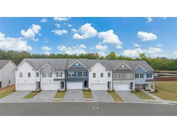 Five townhouses with attached garages, neutral-color exteriors, and landscaping at 1195 Westhampton Way # 144, Villa Rica, GA 30180