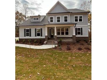 Two story home with gray siding, brick accents, and a front porch at 3780 Chattahoochee Lot 32 Rd, Cumming, GA 30041