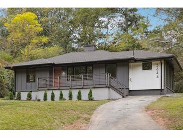 Modern gray house with deck and landscaped yard at 3644 Lakeside Ct, Tucker, GA 30084