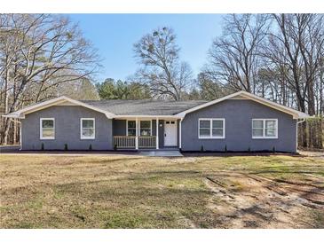 Newly renovated ranch home featuring gray brick exterior and a covered porch at 168 Callaway Rd, Fayetteville, GA 30215