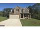 Brick two-story house with a two-car garage at 5696 Laney Dr, Rex, GA 30273