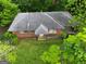 Brick house with gray roof, viewed from above, surrounded by lush green grass and trees at 0 Park Se Ave, Smyrna, GA 30080
