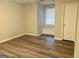 Bright bedroom with window seat and wood-look flooring at 1119 Summer Brook Rd, Atlanta, GA 30349