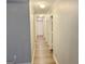 Long hallway with light gray walls and doors at 1119 Summer Brook Rd, Atlanta, GA 30349