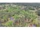 Aerial view of a property with a house and several outbuildings, surrounded by trees at 2421 Bethel Ne Rd, Conyers, GA 30012