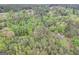 Aerial view of a wooded lot with nearby houses and a road at 2421 Bethel Ne Rd, Conyers, GA 30012