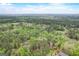 Aerial view of a wooded lot with neighboring houses and open fields at 2421 Bethel Ne Rd, Conyers, GA 30012