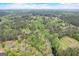 Aerial view of a property with a lake, mature trees and a nearby home at 2421 Bethel Ne Rd, Conyers, GA 30012