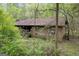 House exterior with wooden siding and large trees at 2421 Bethel Ne Rd, Conyers, GA 30012