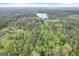 Aerial view of a property with a lake and surrounding woodlands at 2421 Bethel Ne Rd, Conyers, GA 30012