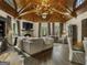 Living room with wood beamed ceiling, stone fireplace, and comfy seating at 131 Burdette Rd, Atlanta, GA 30327