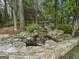 Serene backyard waterfall feature with stone landscaping at 131 Burdette Rd, Atlanta, GA 30327