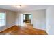 Open living room with hardwood floors and access to another room at 1142 Windsor Sw St, Atlanta, GA 30310