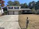 Brick house exterior with a two-car garage and well maintained lawn at 5878 Nell Ln, Ellenwood, GA 30294