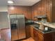 Kitchen with stainless steel appliances and wood cabinets at 5878 Nell Ln, Ellenwood, GA 30294