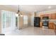 Kitchen with wood cabinets, black appliances, and tiled floor at 6913 Slate Stone Se Way # 2, Mableton, GA 30126