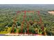 Aerial view of a large wooded lot divided into parcels near a road at 557 Veterans Pkwy, Fayetteville, GA 30214