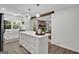 Open concept kitchen with island and view into the living room beyond at 4505 Cochran Mill Rd, Fairburn, GA 30213