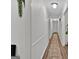 Long hallway with wood flooring and neutral wall colors at 4505 Cochran Mill Rd, Fairburn, GA 30213