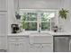 Farmhouse sink with a view of the backyard from the kitchen window at 4505 Cochran Mill Rd, Fairburn, GA 30213