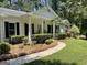 Beautiful white brick home with a classic portico and well-manicured lawn at 4505 Cochran Mill Rd, Fairburn, GA 30213