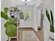 Bright entryway with double doors, wood floors, and large plants at 4505 Cochran Mill Rd, Fairburn, GA 30213