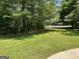 Spacious backyard with lush green grass and mature trees at 4505 Cochran Mill Rd, Fairburn, GA 30213