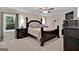 Main bedroom with a large bed, dark wood furniture, and ceiling fan at 4505 Cochran Mill Rd, Fairburn, GA 30213