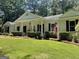 Eye-catching brick home with a two-car garage and neat landscaping at 4505 Cochran Mill Rd, Fairburn, GA 30213
