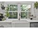 Modern farmhouse sink and expansive window overlooking the backyard at 4505 Cochran Mill Rd, Fairburn, GA 30213