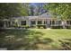 Charming brick ranch home with a spacious front yard and mature trees at 4505 Cochran Mill Rd, Fairburn, GA 30213