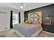 Large bedroom with a ceiling fan and dark accent wall at 4505 Cochran Mill Rd, Fairburn, GA 30213