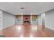 Finished basement with a brick fireplace and hardwood floors at 30 Allie Dr, Mcdonough, GA 30252
